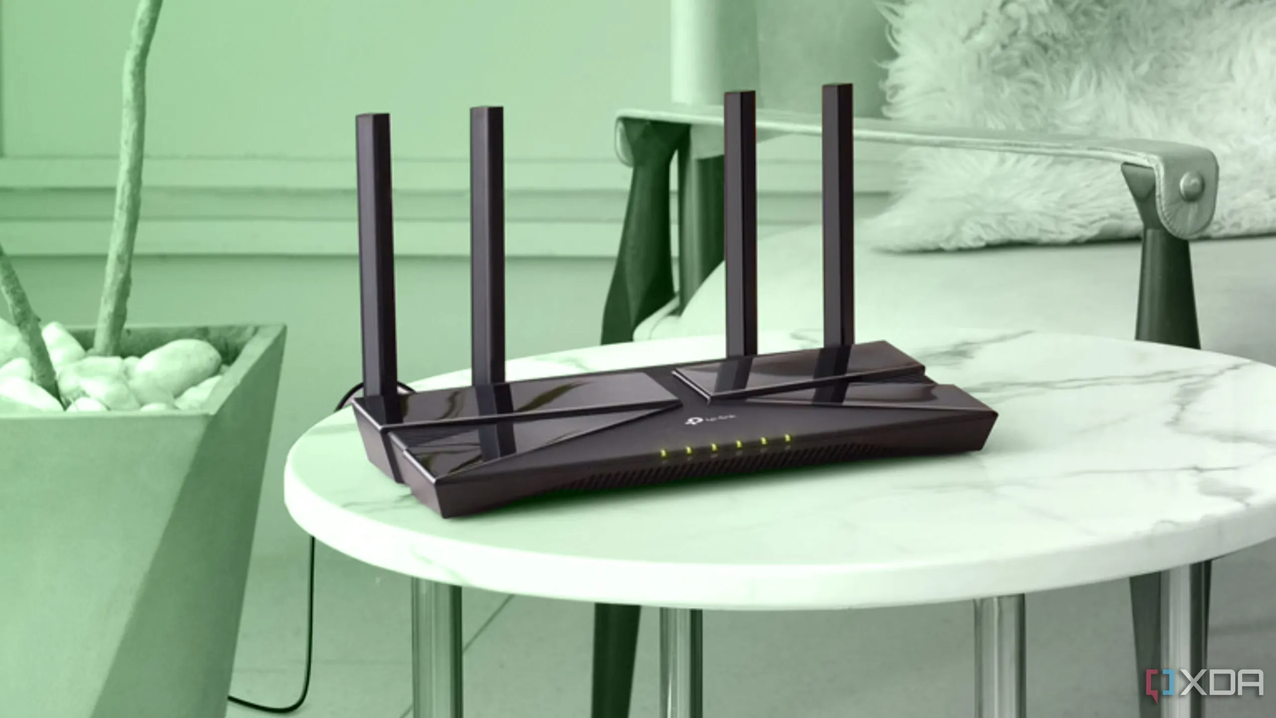 Router WiFi màu đen đặt trên bàn tròn nhỏ với nền xanh