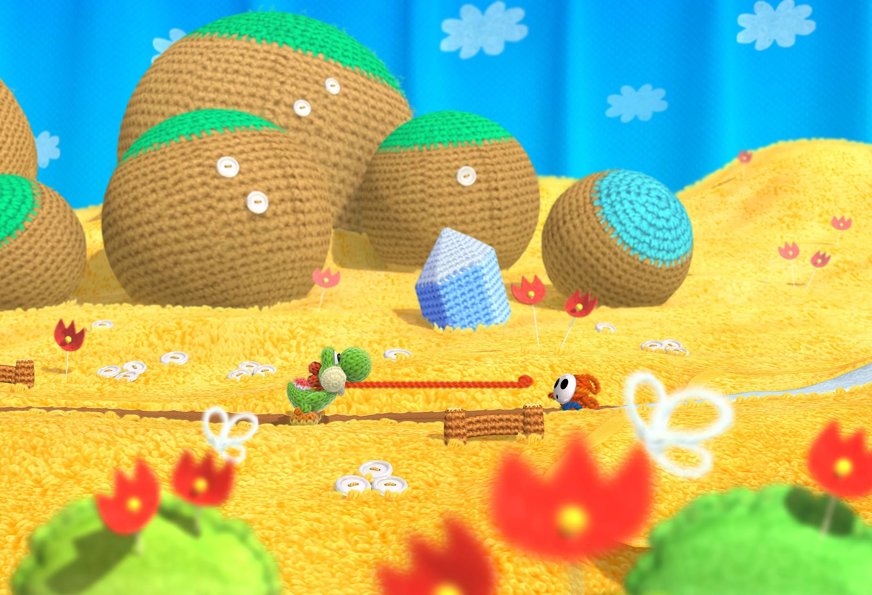 Yoshi trong thế giới len đầy màu sắc của game Yoshi's Woolly World trên Wii U, một tựa game platformer được cộng đồng game thủ Nintendo yêu thích.